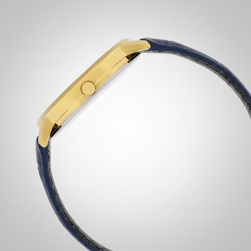 Casio watch side profile with gold case and navy leather strap on grey studio background